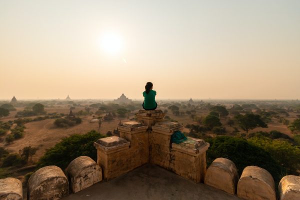 lone-person-sits-on-top-of-a-temple-overlooking-old-bagan-myanmar.jpg